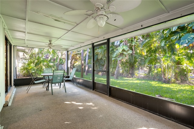 unfurnished sunroom featuring ceiling fan