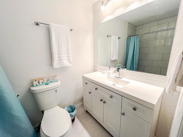 bathroom with vanity, curtained shower, and toilet