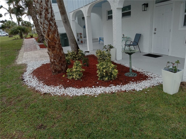 exterior space with a lawn and a patio area