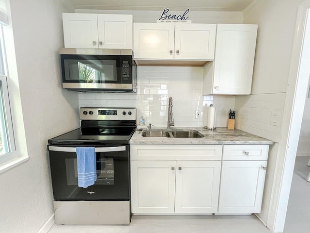 kitchen featuring white cabinetry, stainless steel appliances, and sink