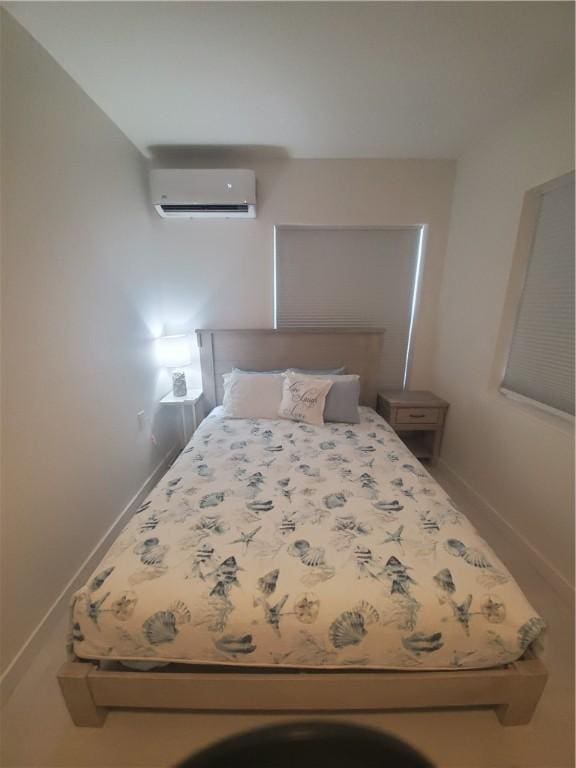 unfurnished bedroom with a wall unit AC