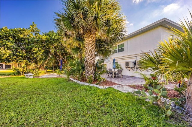 view of yard with ac unit and a patio area