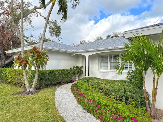 doorway to property featuring a yard