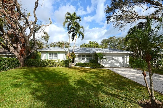 single story home with a garage and a front lawn