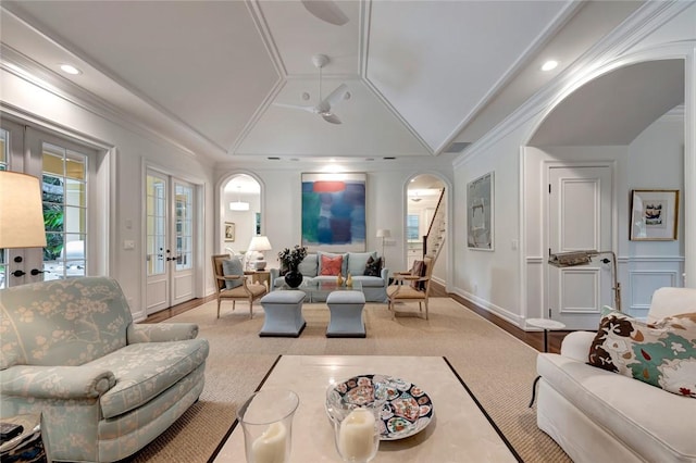 living room with lofted ceiling, crown molding, and french doors