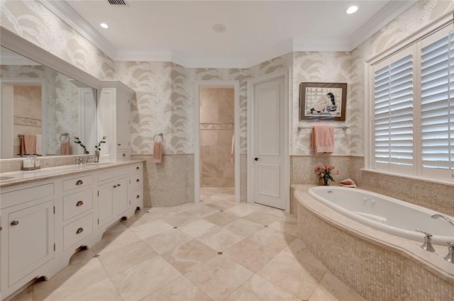 bathroom with crown molding, vanity, and a relaxing tiled tub