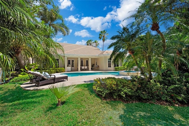 view of swimming pool with a patio and a yard