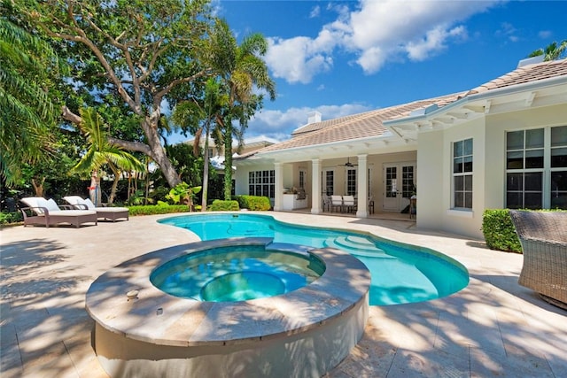 view of pool featuring an in ground hot tub, ceiling fan, outdoor lounge area, and a patio