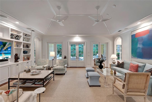 living room with french doors, lofted ceiling, ornamental molding, ceiling fan, and built in shelves