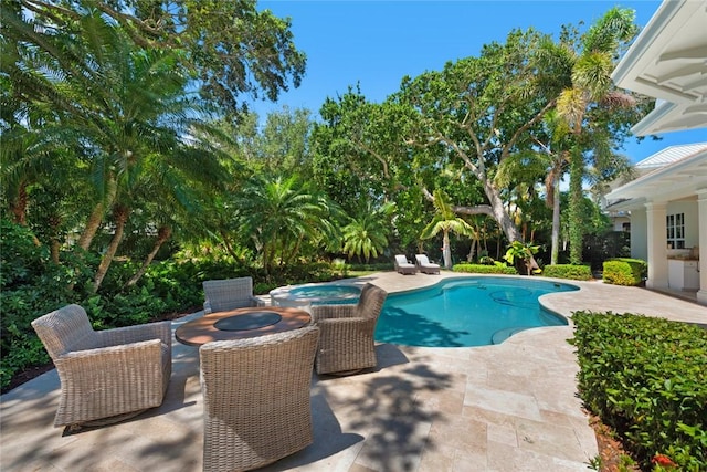 view of pool with an in ground hot tub and a patio