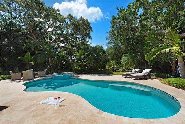 view of swimming pool with a patio area and an in ground hot tub