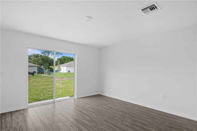 7860 97th Ave, Vero Beach, FL 32967 - spare room featuring wood finished floors and baseboards