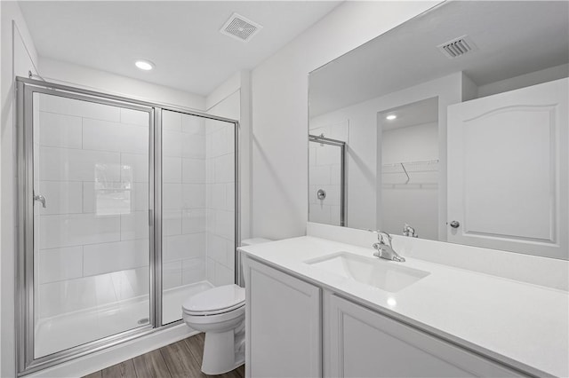 7860 97th Ave, Vero Beach, FL 32967 - full bathroom featuring toilet, a stall shower, wood finished floors, vanity, and recessed lighting