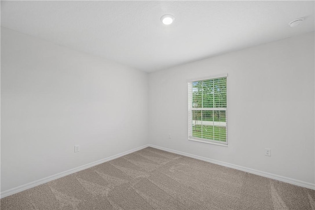 7860 97th Ave, Vero Beach, FL 32967 - carpeted spare room featuring baseboards and a smoke detector