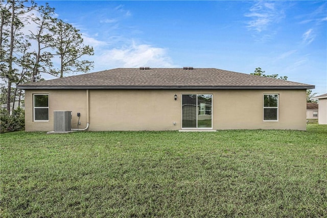 7860 97th Ave, Vero Beach, FL 32967 - rear view of house featuring stucco siding, central air condition unit, and a lawn