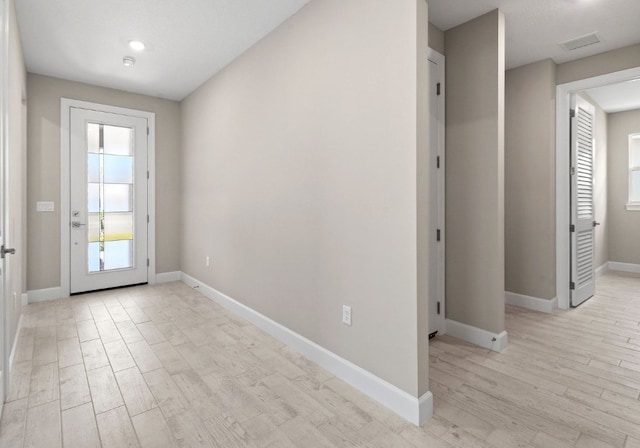 1251 Haven Unit Prestige 37, Vero Beach, FL 32960 - doorway featuring light wood-style floors and baseboards