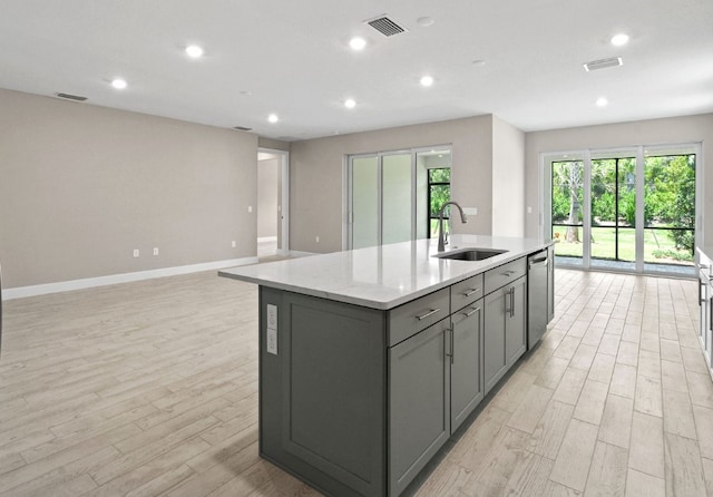1251 Haven Unit Prestige 37, Vero Beach, FL 32960 - kitchen with a sink, gray cabinetry, dishwasher, open floor plan, and light wood-type flooring