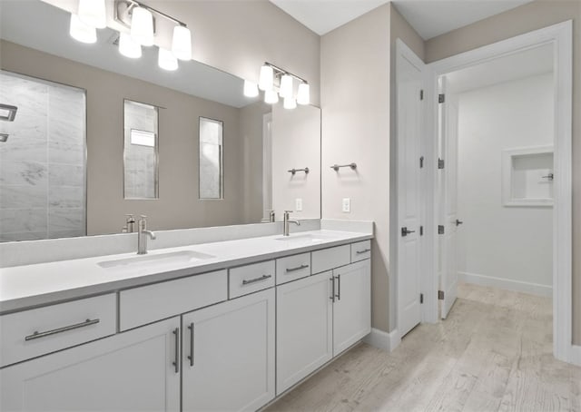 1251 Haven Unit Prestige 37, Vero Beach, FL 32960 - bathroom featuring wood finished floors, double vanity, and baseboards