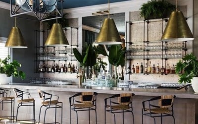 bar featuring a chandelier and ornamental molding