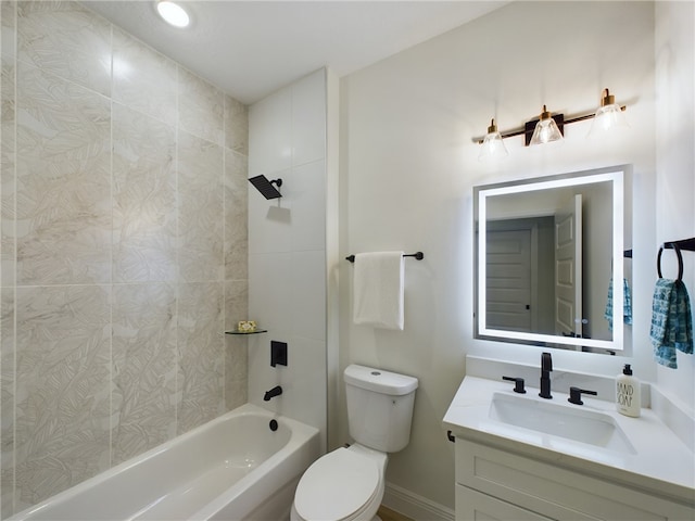 full bathroom featuring toilet, vanity, and tiled shower / bath