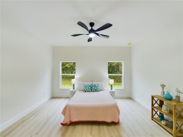 bedroom with ceiling fan and light wood-type flooring