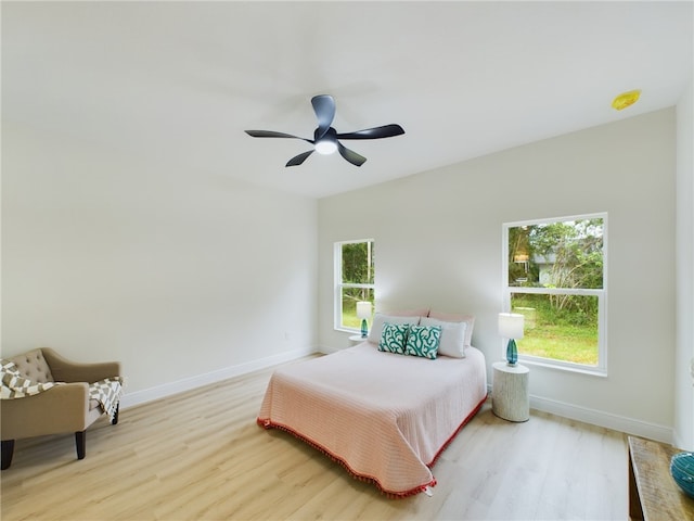 bedroom with ceiling fan and light wood-type flooring