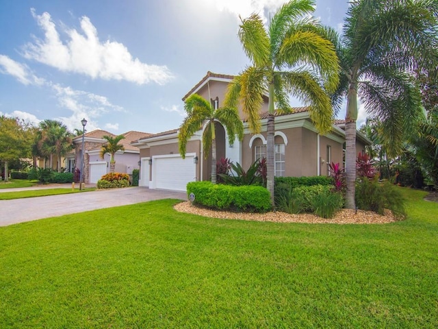 1745 Belmont Cir SW, Vero Beach, FL 32968 - mediterranean / spanish house with driveway, stucco siding, a front lawn, and an attached garage