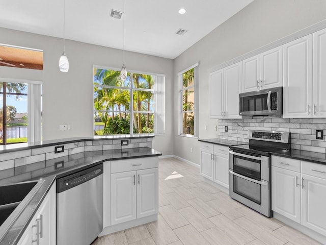 kitchen with white cabinetry, a healthy amount of sunlight, and appliances with stainless steel finishes