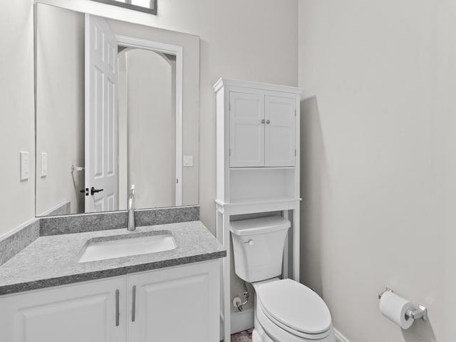 bathroom with toilet and vanity