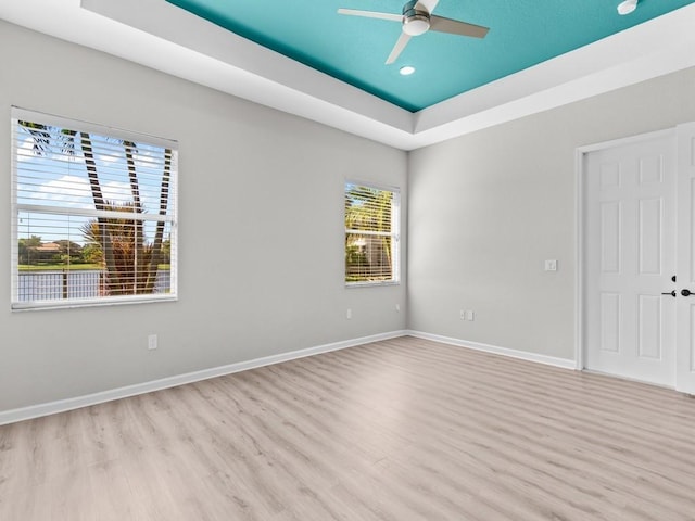 1745 Belmont Cir SW, Vero Beach, FL 32968 - spare room featuring wood finished floors, a tray ceiling, ceiling fan, and recessed lighting