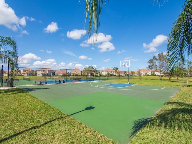 view of basketball court with a lawn