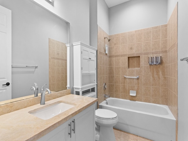 full bathroom with vanity, tile patterned floors, toilet, and tiled shower / bath combo