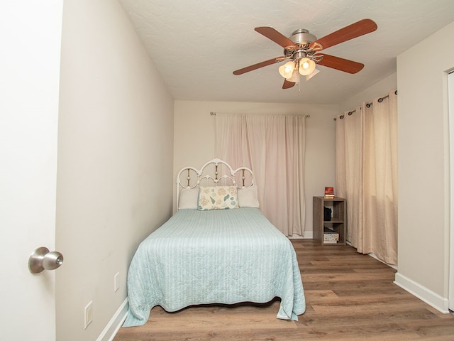 bedroom with hardwood / wood-style floors and ceiling fan