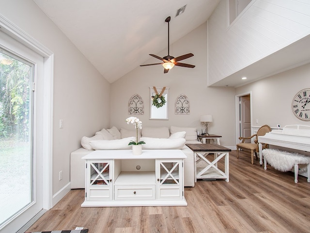 living room featuring ceiling fan, light wood-type flooring, and high vaulted ceiling