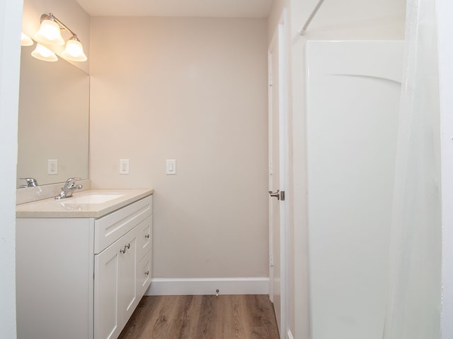 bathroom with hardwood / wood-style floors and vanity