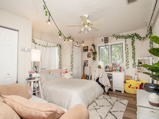 bedroom with ceiling fan, a closet, and wood-type flooring