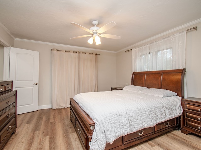 bedroom featuring ceiling fan, light hardwood / wood-style floors, and crown molding