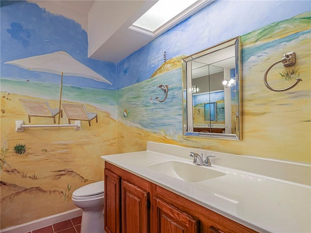 bathroom featuring vanity, a skylight, tile patterned flooring, and toilet