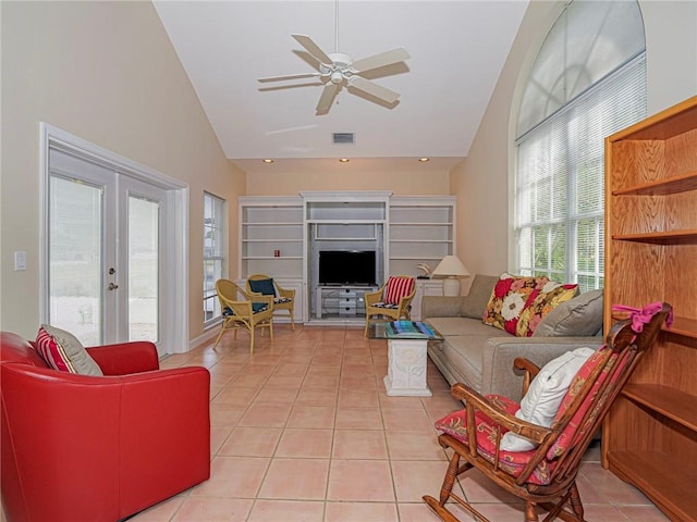 living room with french doors, light tile patterned floors, visible vents, ceiling fan, and high vaulted ceiling