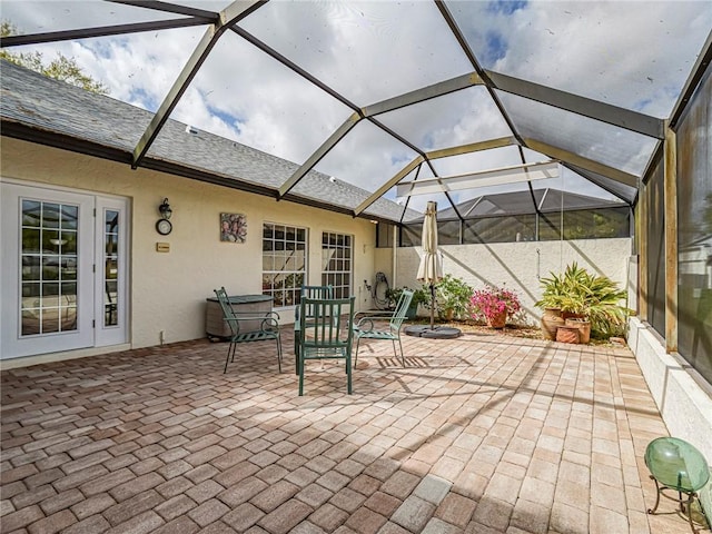 view of patio featuring glass enclosure