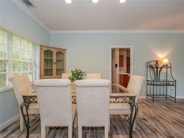 dining space with recessed lighting, wood finished floors, visible vents, baseboards, and crown molding