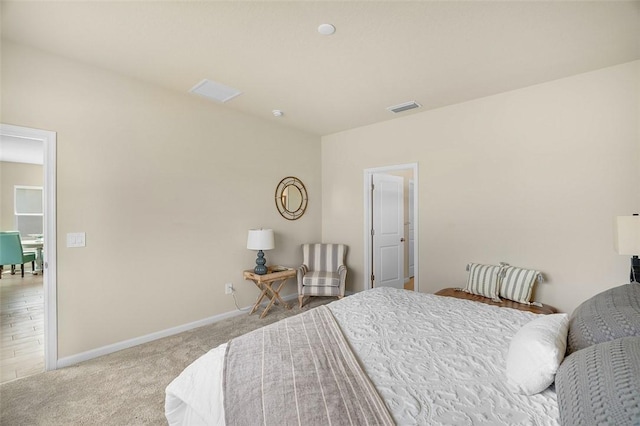 carpeted bedroom with visible vents and baseboards