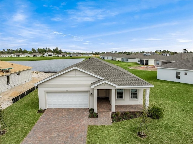 4385 Lago Cir, Vero Beach, FL 32967 - single story home with a residential view, a garage, decorative driveway, and a front lawn