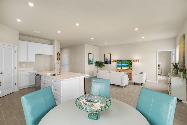 dining area with baseboards, wood finish floors, and recessed lighting