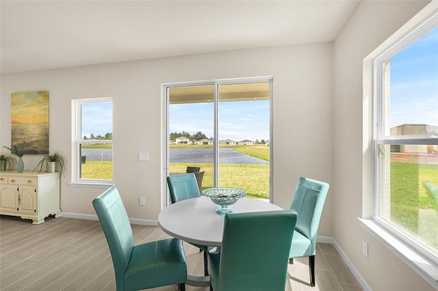 dining area featuring light wood-style floors and baseboards