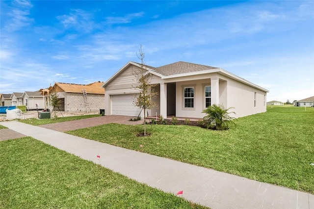 single story home featuring a shingled roof, an attached garage, decorative driveway, a front yard, and stucco siding