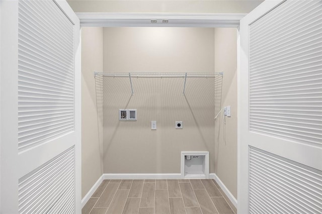 clothes washing area featuring laundry area, wood tiled floor, baseboards, and hookup for an electric dryer