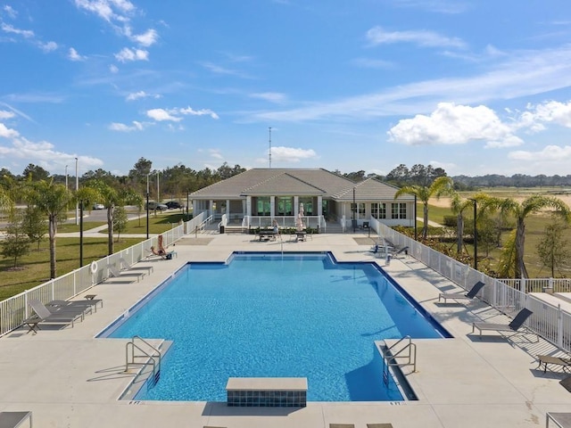 community pool featuring a patio and fence