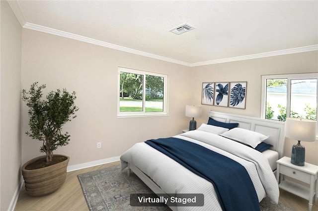 bedroom featuring multiple windows, crown molding, and light hardwood / wood-style flooring