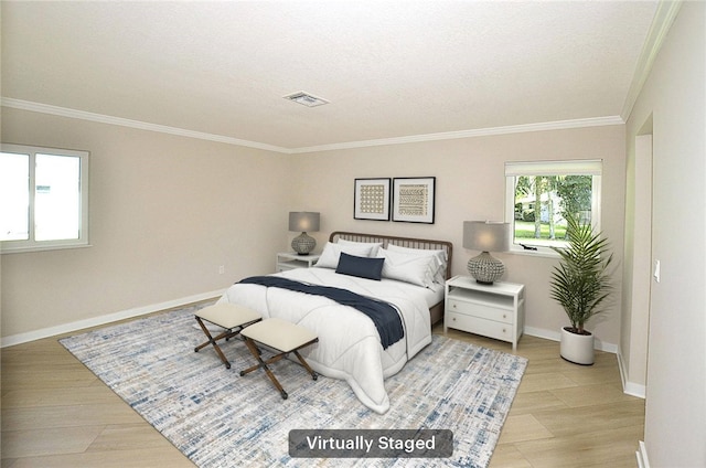 bedroom featuring a textured ceiling, light hardwood / wood-style floors, and crown molding